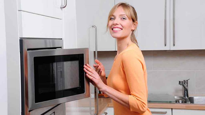 woman opening convection microwave